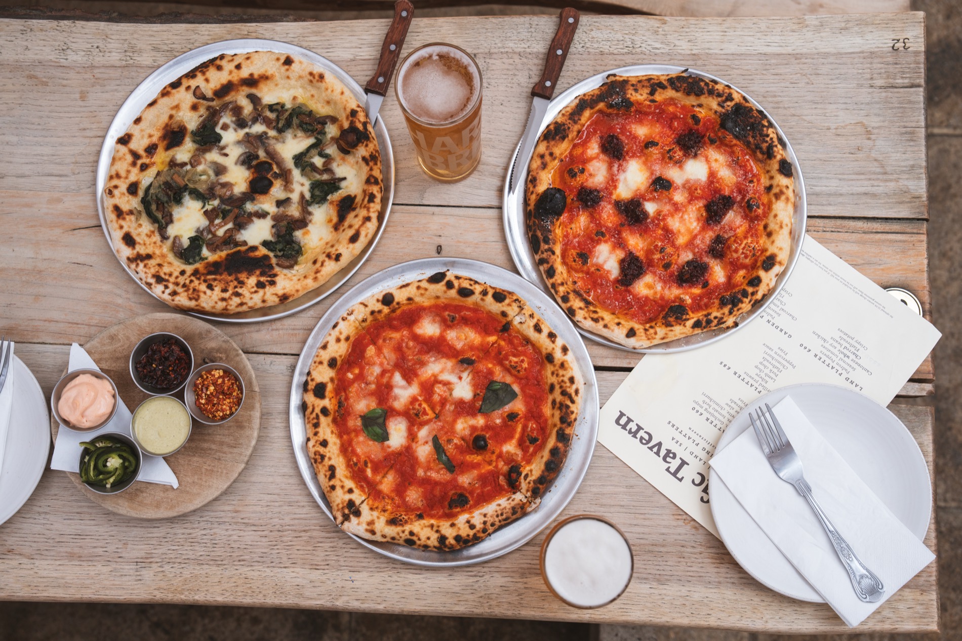 Pacific Tavern pizzas on a wooden table