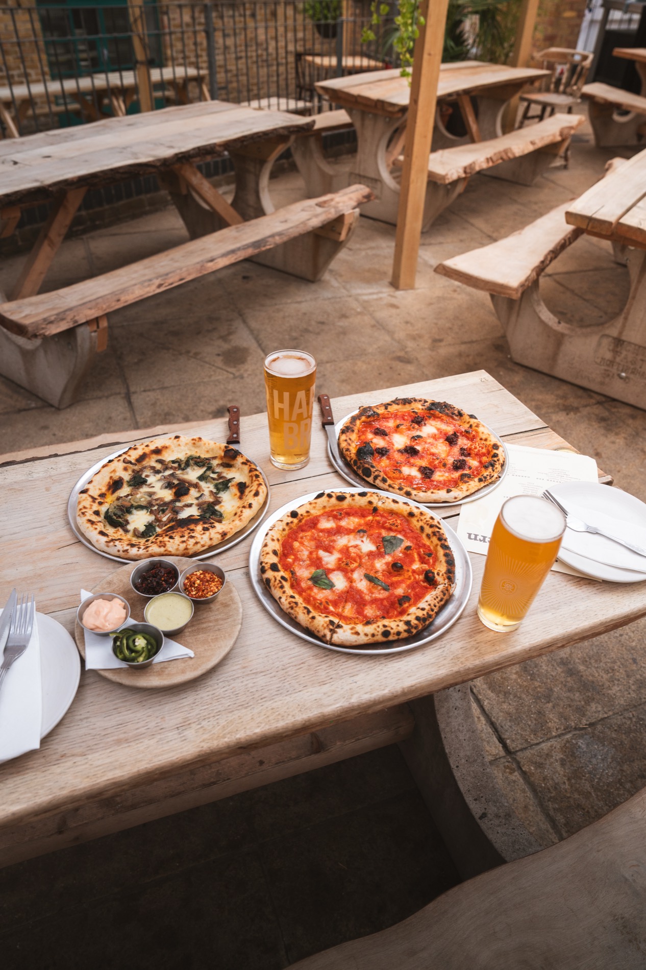Pacific Tavern pizzas on outdoor picnic table