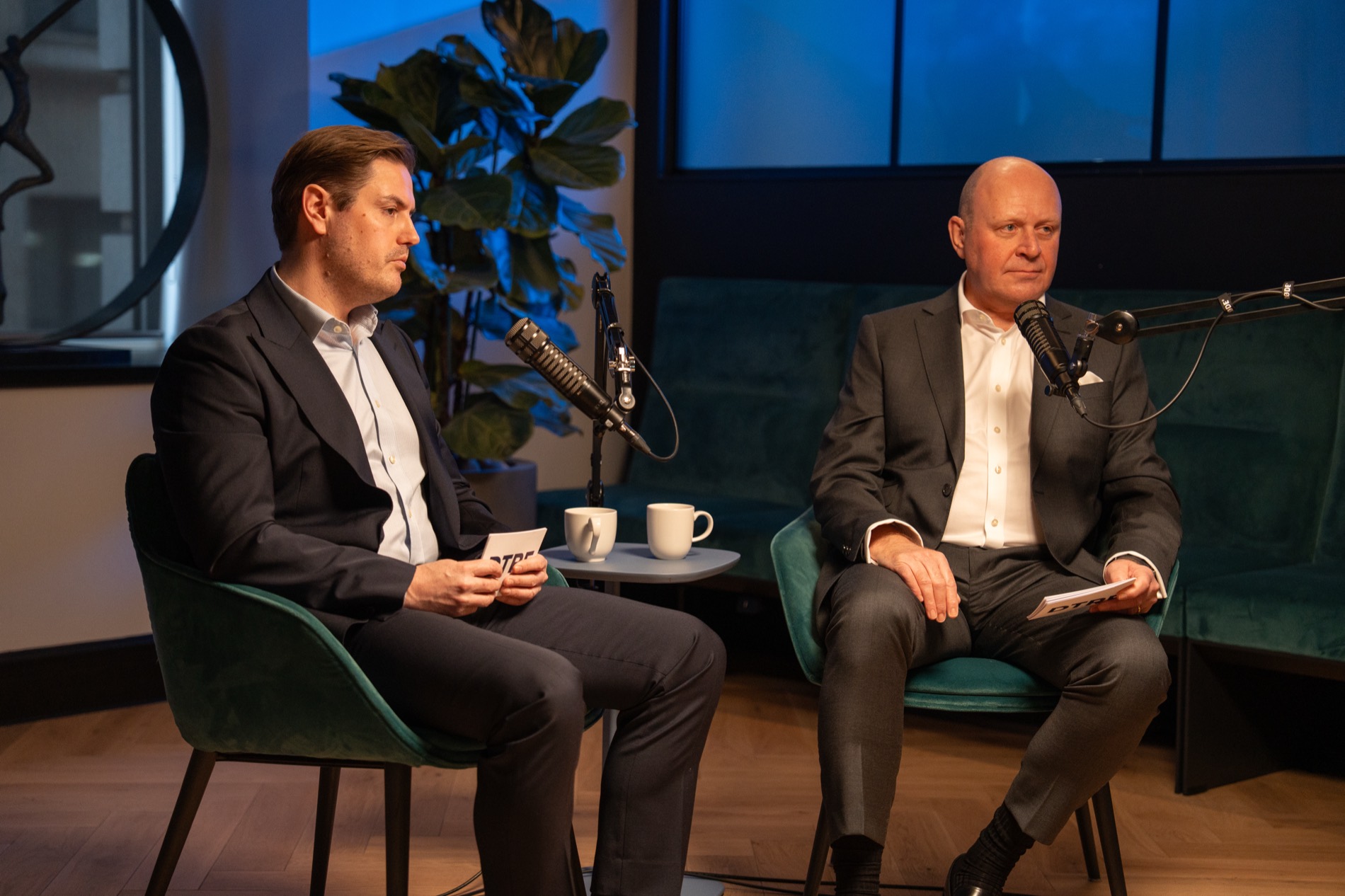 Two guests seated on a broadcast studio set