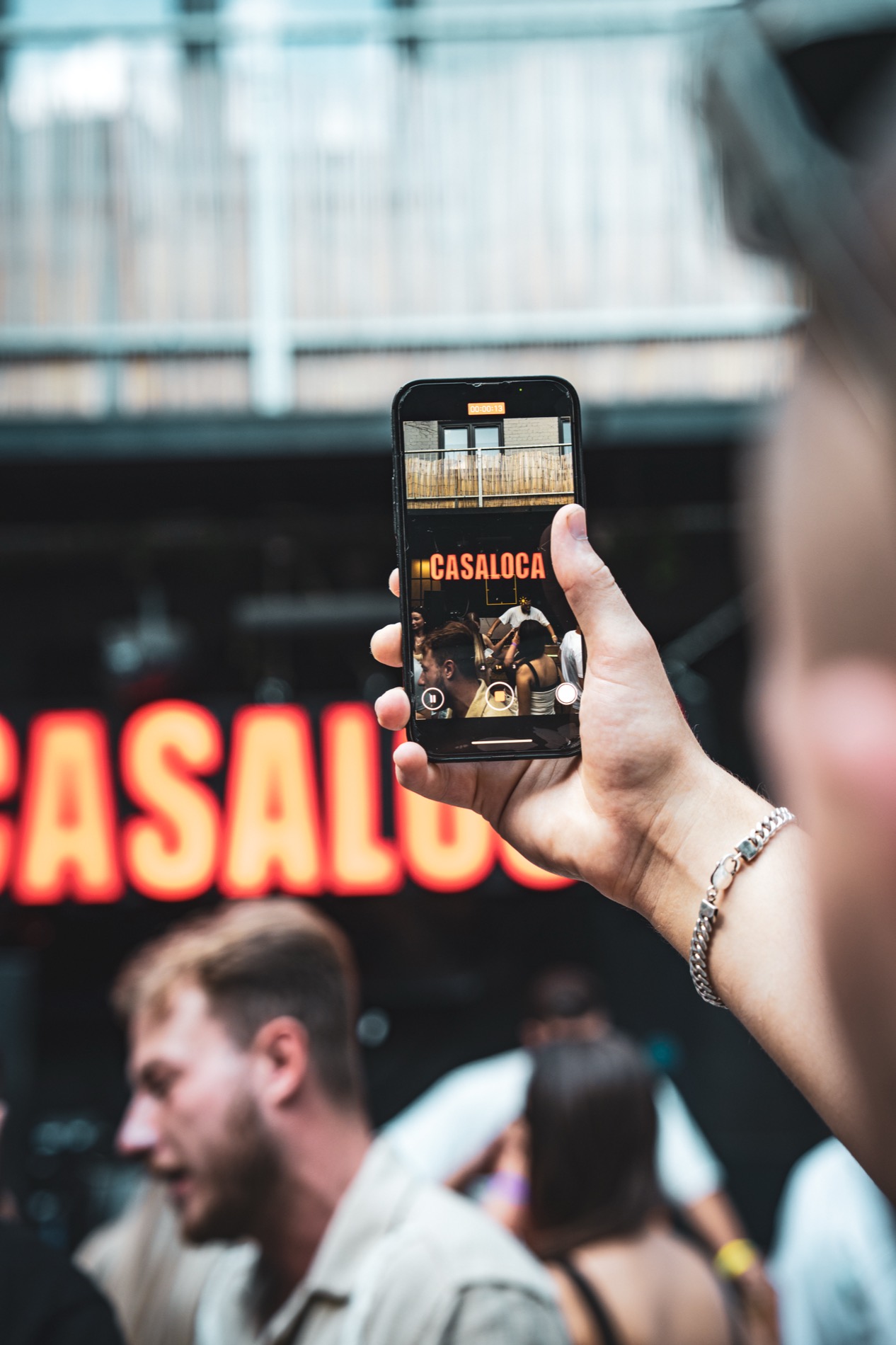 Guest filming Casaloca signage on a phone